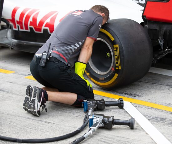 F1 mechanic working on a tyre
